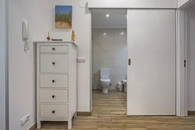 a bathroom with a white dresser and a toilet at Apartment - The Historical Center of Funchal in Alojamento Local in Funchal