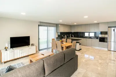 a living room with a couch and a kitchen at Casa Barros Serra in Calheta