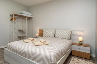 a bedroom with a bed with towels on it at Casa Barros Serra in Calheta