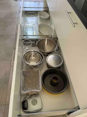 a drawer with many pots and pans in a kitchen at Moradia com piscina no Caniço in Caniço