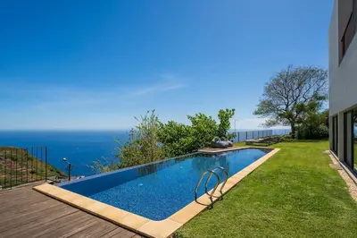 a swimming pool with a view of the ocean at Botanica Living Magnolia Apt in Quinta Grande
