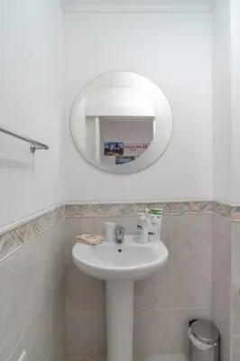 a kitchen with white cabinets and stainless steel appliances at Jardins da Ajuda Apartment in Funchal
