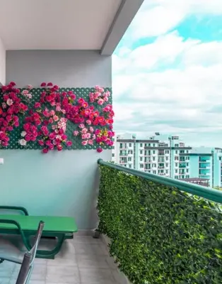 a balcony with pink flowers on a wall at Jardins da Ajuda Apartment in Funchal