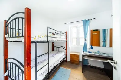 a bedroom with two bunk beds and a desk at Villa bela vista 20th century house in Funchal