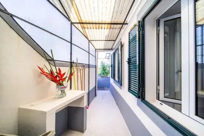 a hallway of a building with a vase of flowers at Villa bela vista 20th century house in Funchal
