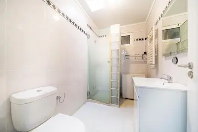 a bathroom with a toilet and a sink and a shower at Villa bela vista 20th century house in Funchal