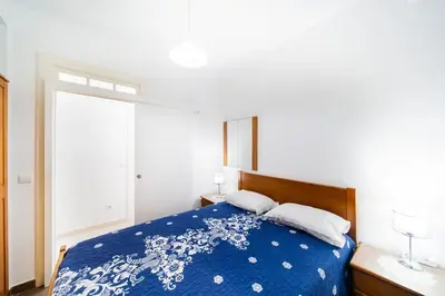 a bedroom with a blue and white bed with two pillows at Villa bela vista 20th century house in Funchal