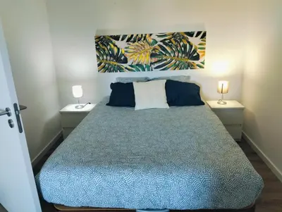 a bedroom with a large bed with two night stands at Casa do Sol in Funchal