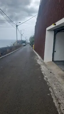 an empty street next to a building and a building at Casa do Sol in Funchal