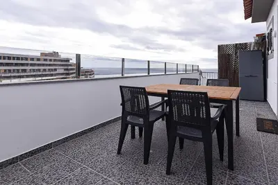 a table and chairs on a balcony with a view at Casa do Sol in Funchal