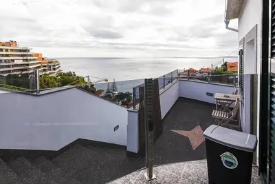 a balcony of a house with a view of the ocean at Casa do Mar in Funchal