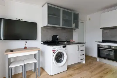 a kitchen with a washing machine and a sink at Casa do Mar in Funchal