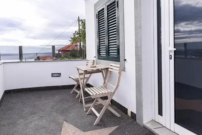 a table and chairs on the balcony of a house at Casa do Mar in Funchal