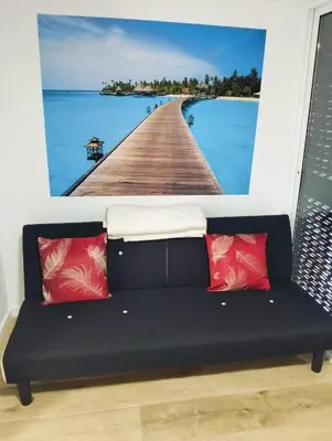 a couch in a room with a picture of a pier at Casa do Mar in Funchal