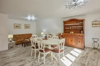 a dining room with a table and chairs and a couch at Casas Maravilha - Casa Grande by Homie in Calheta