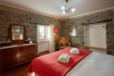 a bedroom with a bed with two towels on it at Casas Maravilha - Casa Grande by Homie in Calheta