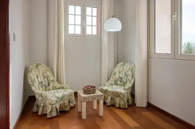 two chairs and a table in a room at Casas Maravilha - Casa Grande by Homie in Calheta