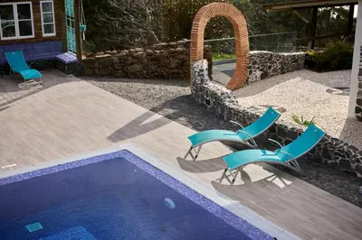 two chairs and a swimming pool in a yard at Casas Maravilha - Casa Grande by Homie in Calheta