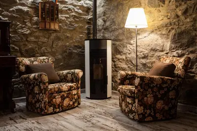 a living room with two chairs and a heater at Casas Maravilha - Casa Grande by Homie in Calheta