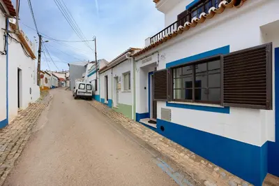 an empty street in a town with buildings at Casa Brita in Raposeira