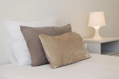 a white bed with a pillow and a lamp at Villa Blue Sagres D in Sagres