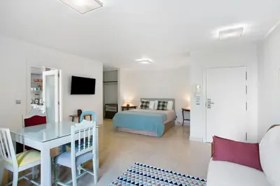a living room with a bed and a table at Forum T0 Plus in Funchal