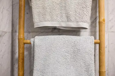 three towels are hanging on a towel rack at Forum T0 Plus in Funchal