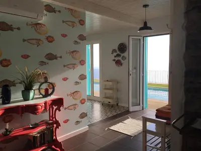 a living room with a wall with fish decals at Villa Pargo in Fajã da Ovelha