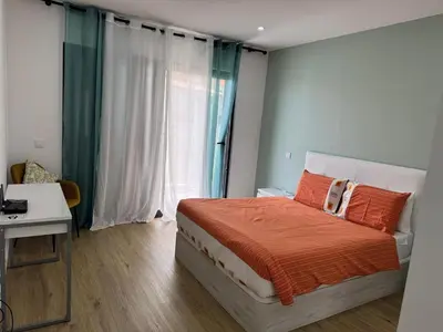 a bedroom with a bed and a desk and a window at B - BEAUTIFUL 2 Bedroom Modern Townhouse with Private Parking in Machico