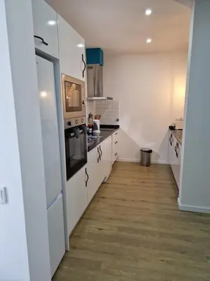 a kitchen with white cabinets and a stove at B - BEAUTIFUL 2 Bedroom Modern Townhouse with Private Parking in Machico