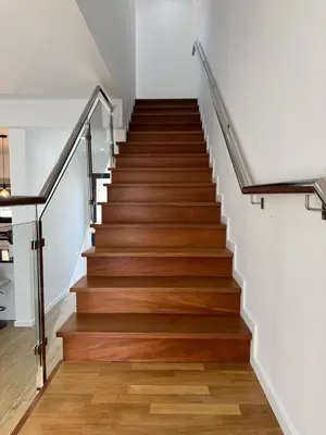 a staircase in a house with wooden floors and white walls at B - BEAUTIFUL 2 Bedroom Modern Townhouse with Private Parking in Machico
