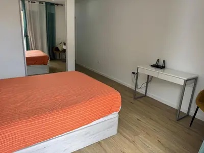 a room with a bed and a desk and a mirror at B - BEAUTIFUL 2 Bedroom Modern Townhouse with Private Parking in Machico