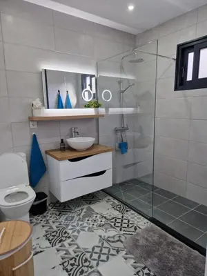 a bathroom with a shower and a sink and a toilet at B - BEAUTIFUL 2 Bedroom Modern Townhouse with Private Parking in Machico