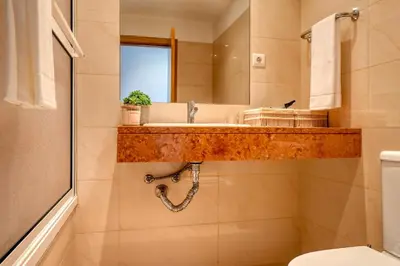 a bathroom with a sink and a mirror at Funchal Atrium, a Home in Madeira in Funchal