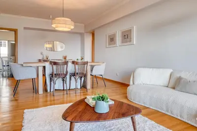 a living room with a couch and a table at Funchal Atrium, a Home in Madeira in Funchal
