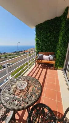 a balcony with a table and chairs and the ocean at Seaview Relax Apartment in Caniço