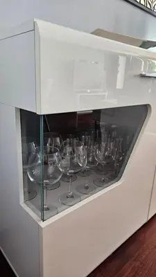 a row of wine glasses in a white cabinet at Seaview Relax Apartment in Caniço