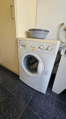 a washing machine with a pan on top of it at Seaview Relax Apartment in Caniço