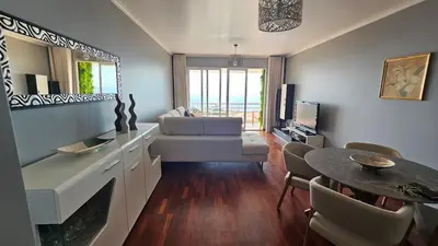 a living room with a couch and a table at Seaview Relax Apartment in Caniço