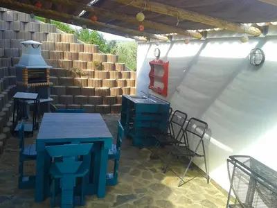 a patio with a table and chairs under a tent at Barranco do Zambujeiro in Vila do Bispo