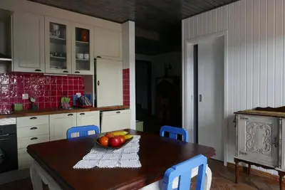 a kitchen with a table with a bowl of fruit on it at Barranco do Zambujeiro in Vila do Bispo