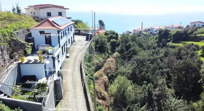 a building on the side of a hill at Espirito do Mar - Premium Villa with Jacuzzi in Estreito da Calheta