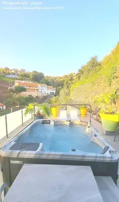 a large swimming pool on top of a patio at Espirito do Mar - Premium Villa with Jacuzzi in Estreito da Calheta