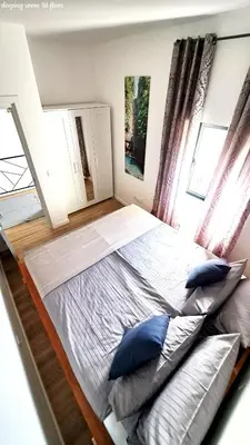 a large bed with blue pillows in a bedroom at Espirito do Mar - Premium Villa with Jacuzzi in Estreito da Calheta