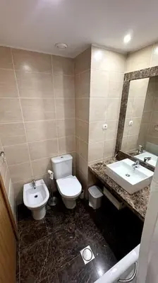 a bathroom with a toilet and a sink at By the Sea IV - Cosy flat in Funchal