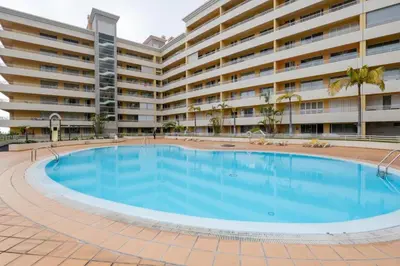 a large swimming pool in front of a large apartment building at By the Sea IV - Cosy flat in Funchal