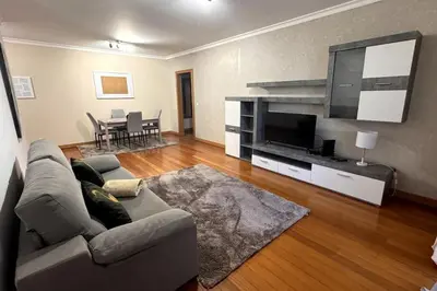 a living room with a couch and a flat screen tv at By the Sea IV - Cosy flat in Funchal