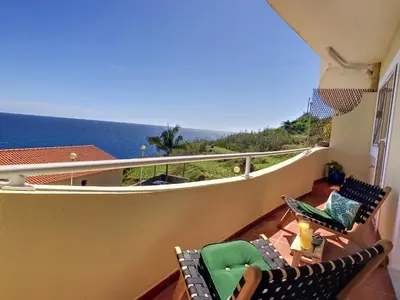 a balcony with chairs and a view of the ocean at Portinho's View by LovelyStay in Caniço