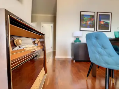 a living room with a couch and a flat screen tv at Portinho's View by LovelyStay in Caniço