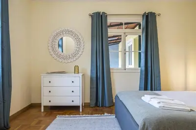 a bedroom with a bed and a mirror and a dresser at Quinta dos Landeiros - Prosa Verde by Homie in Machico
